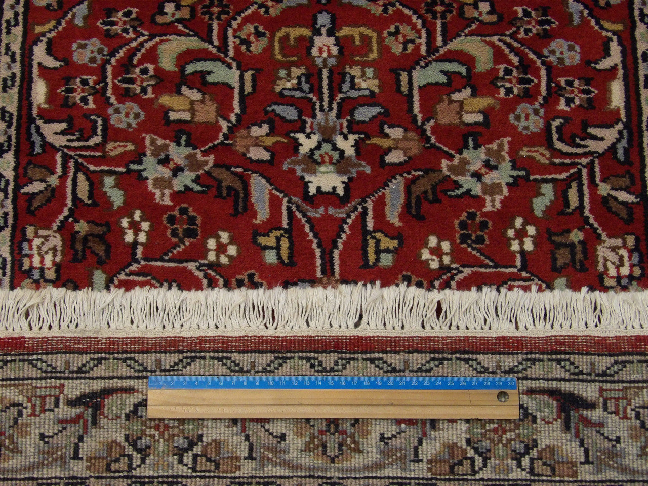 Beige and red Kashan runner in hallway setting