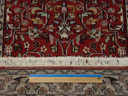 Beige and red Kashan runner in hallway setting