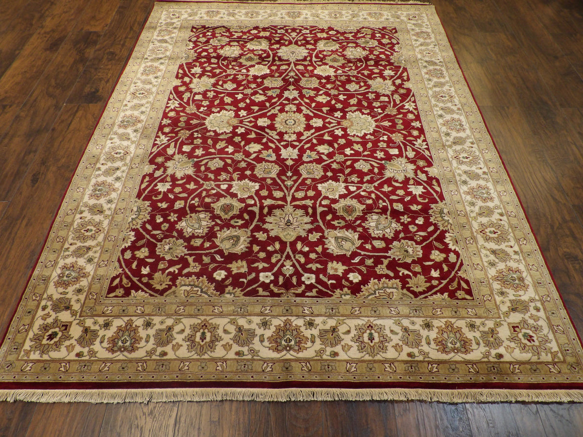 Close-up of wool pile, beige and red rug
