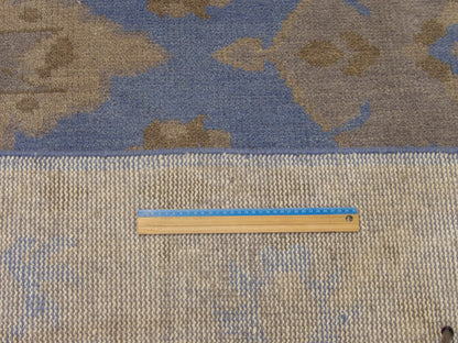 Blue and gray Oushak rug in room setting