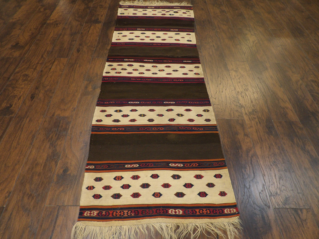Back of hand-knotted antique kilim runner showing reversible weave