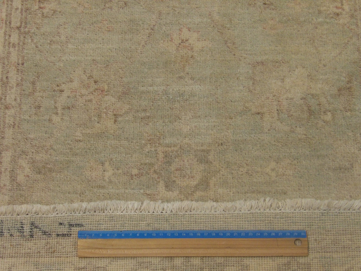 Green & Ivory Oushak Chobi Wash rug in room setting
