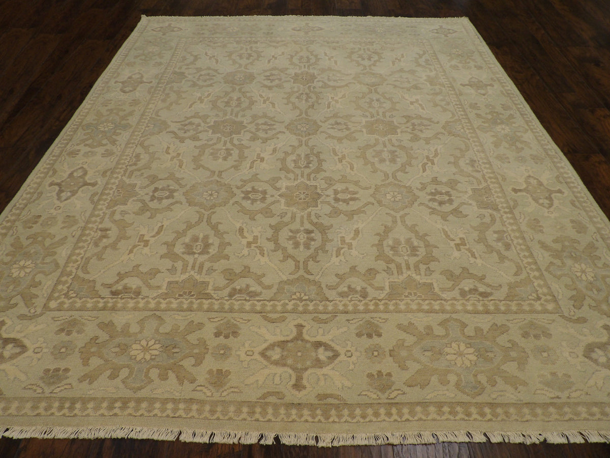 Close-up of wool pile, green and beige rug