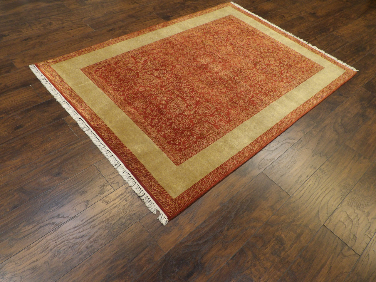 Carved pile pattern detail, gold and red rug