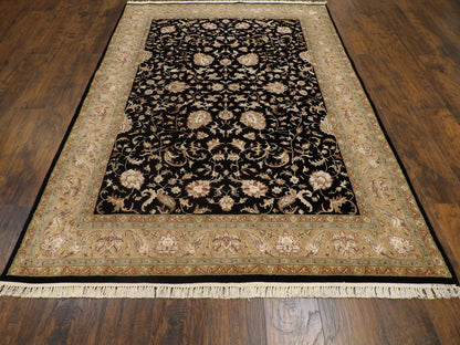 Close-up of silky wool-silk pile, black and gold rug