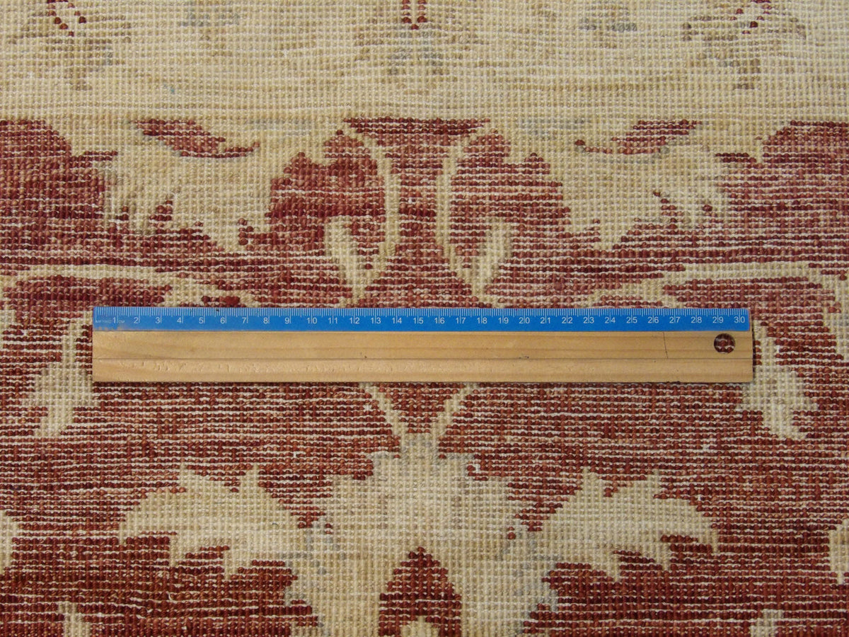 Beige and red Oushak rug in room setting