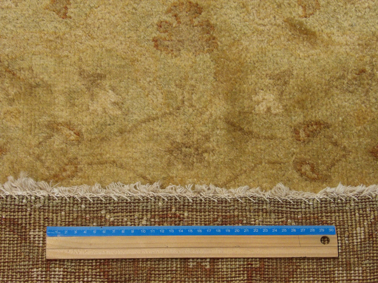 Brown and gold Oushak runner in hallway setting