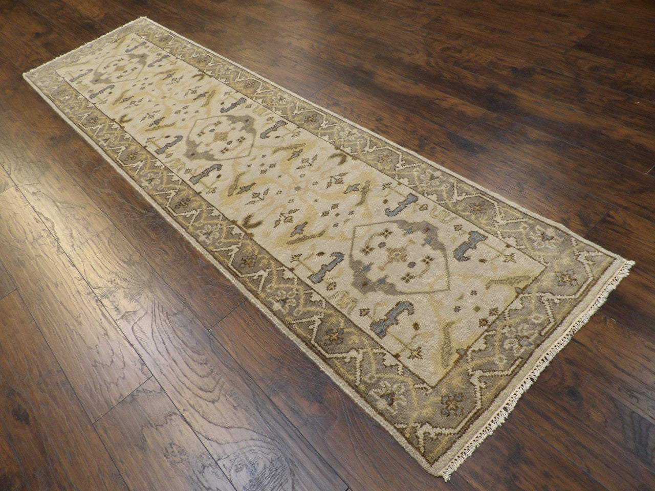 Beige and gray Oushak runner in a hallway setting