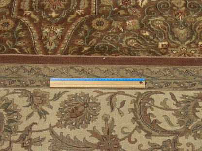 Brown and gold Mashad rug in room setting