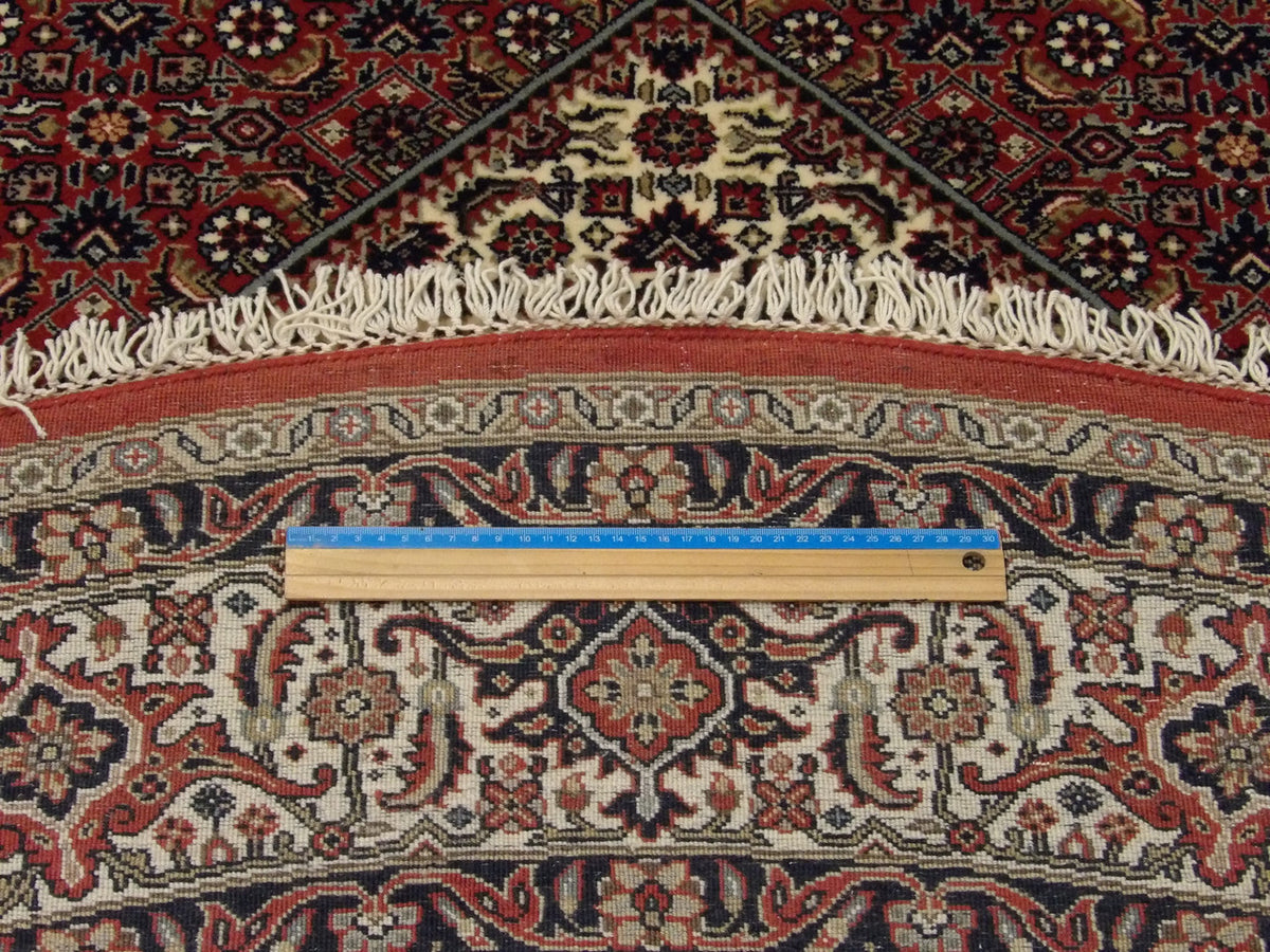 Beige and red Mir Bidjar round rug in room setting
