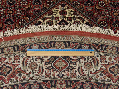 Beige and red Mir Bidjar round rug in room setting