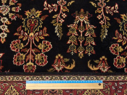 Black & Red Fine Persian Sharookh rug in room setting