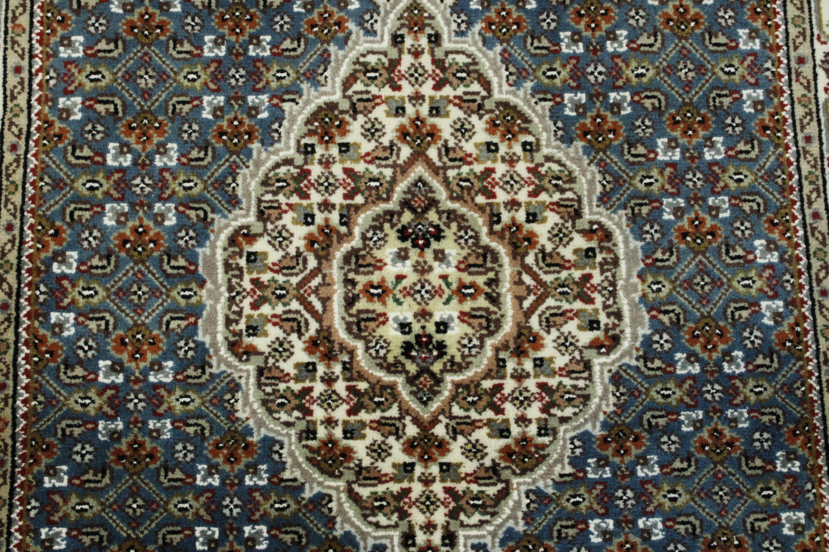 Traditional Tabriz rug corner detail