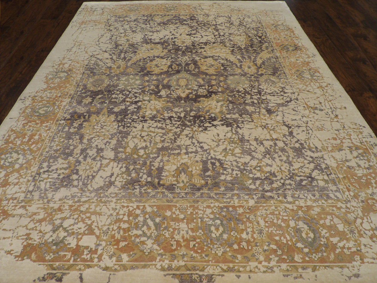 Close-up of wool-silk pile, beige and purple rug