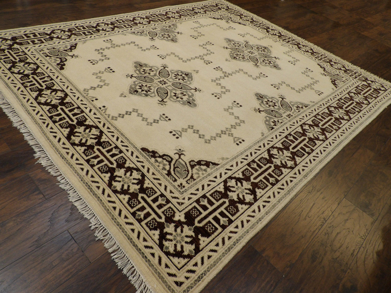 Kazak geometric pattern detail, brown and ivory silver wash rug