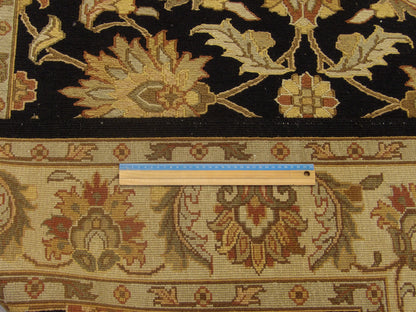 Black and gold Kashan rug in room setting