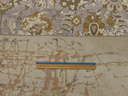 Beige and purple vintage rug in room setting