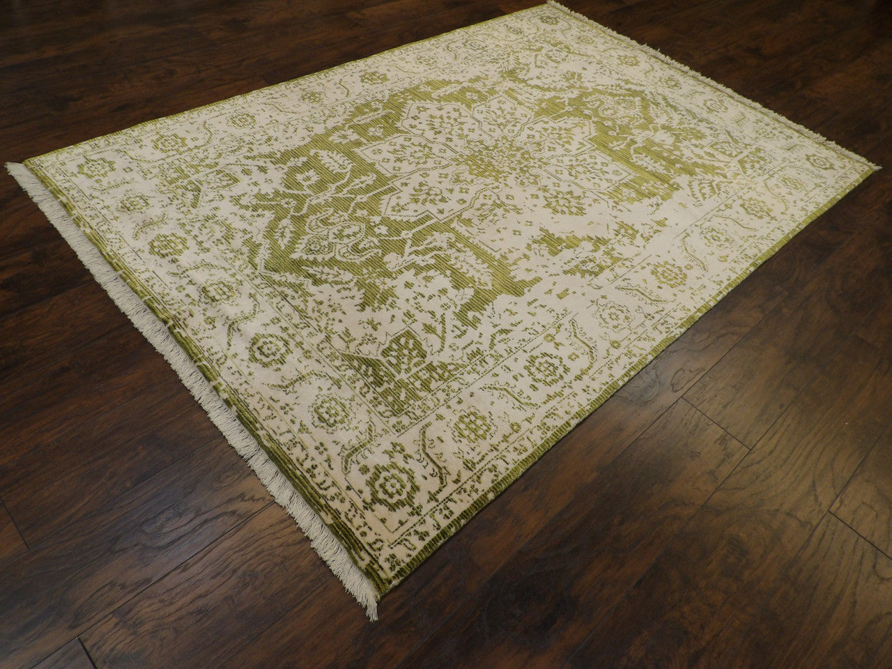 Broken Heriz pattern detail, green rug