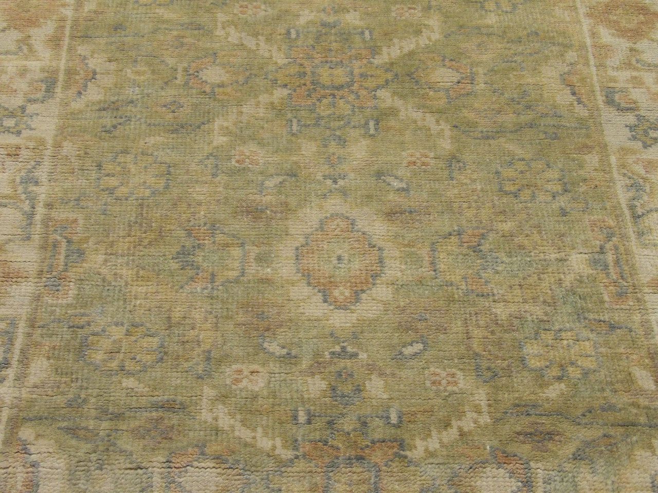 Wool texture close-up, beige and green Oushak runner