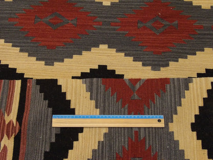 Gray and rust coastal rug in room setting