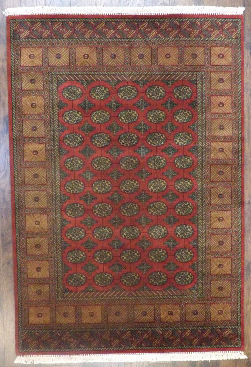 Tribal Bokhara elephant foot hand-knotted wool rug in gold and red, full view