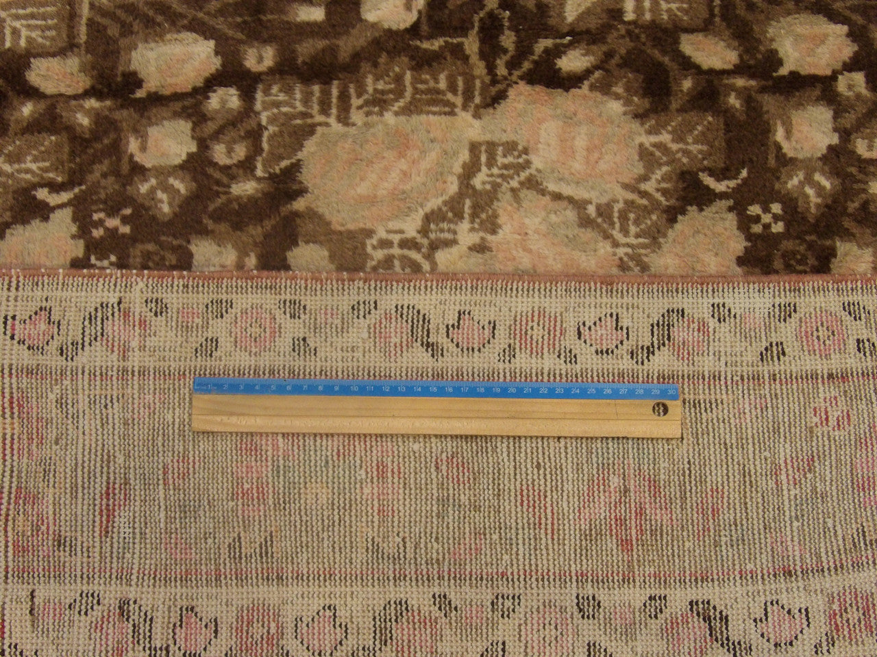 Brown and pink Khotan Oushak rug in room setting