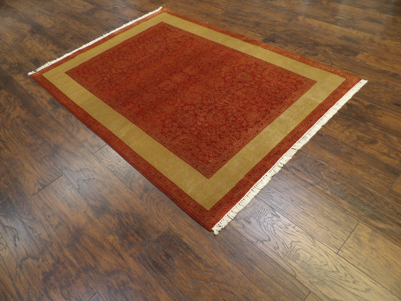 Gold carved French rug in a formal room setting
