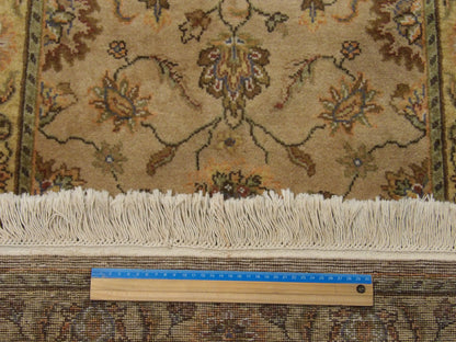 Gold and green Kashan runner in hallway setting