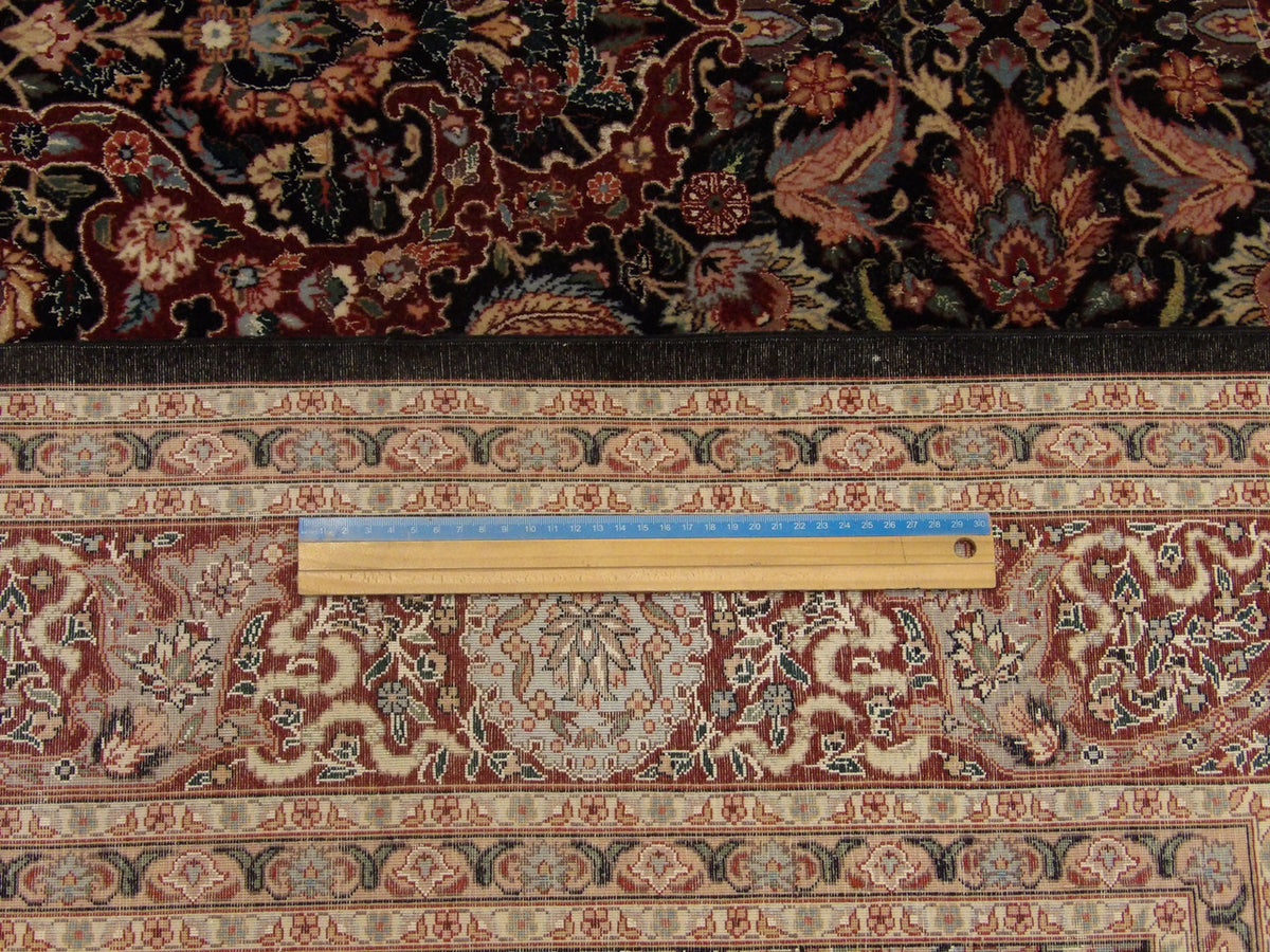 Black and red Kashan rug in room setting