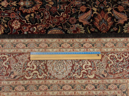 Black and red Kashan rug in room setting