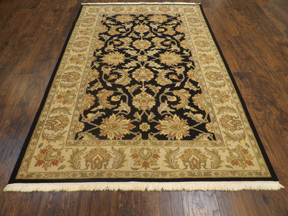 Close-up of flat weave texture, black and gold rug