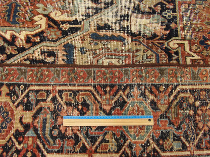 Blue and brown antique Heriz rug in room setting