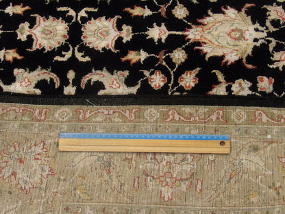 Black and gold Kashan rug in room setting
