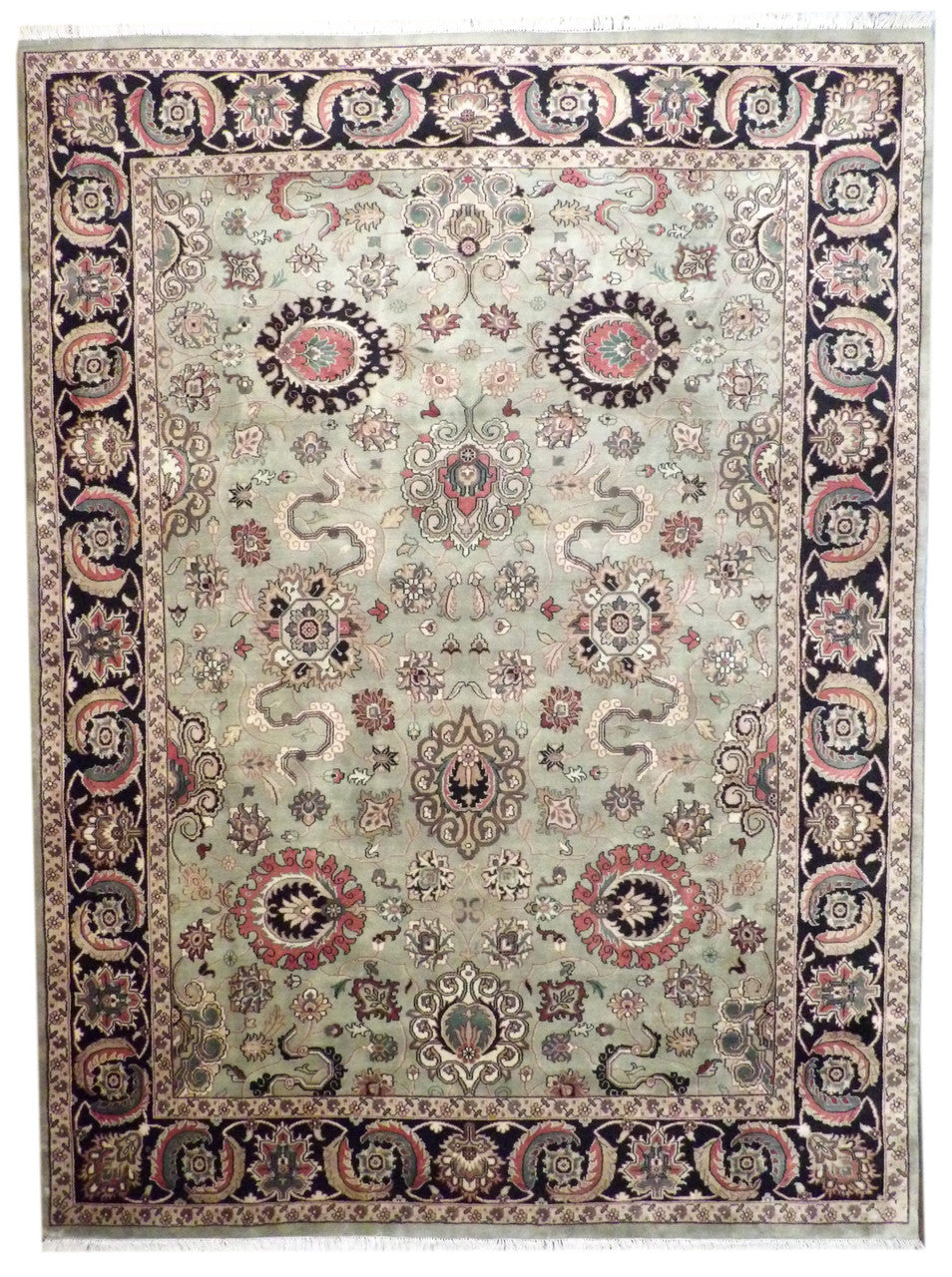 Fine Persian Mashad hand-knotted wool rug in black and green, full view