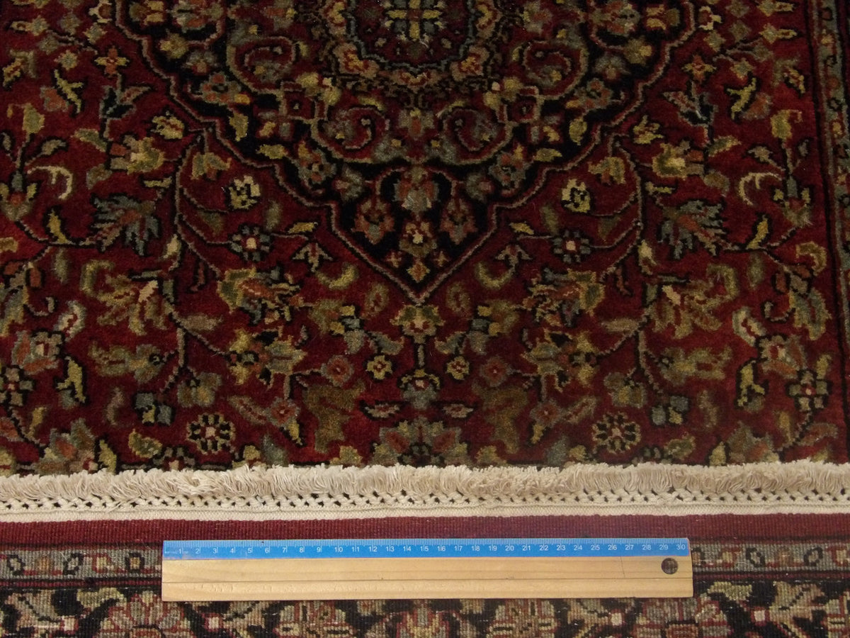 Blue and red Tabriz runner in hallway setting