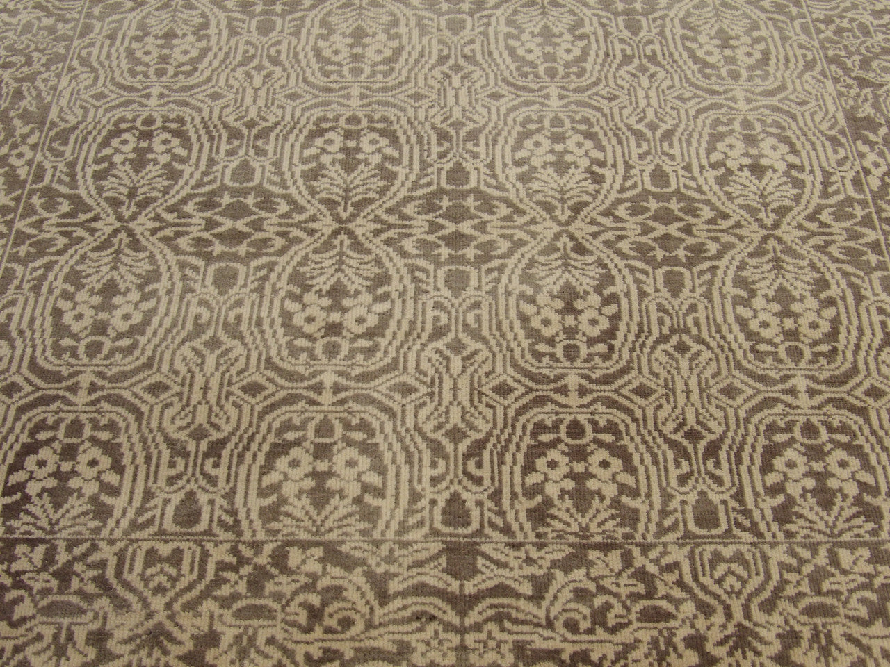 Damask rug border and corner detail, brown and gold