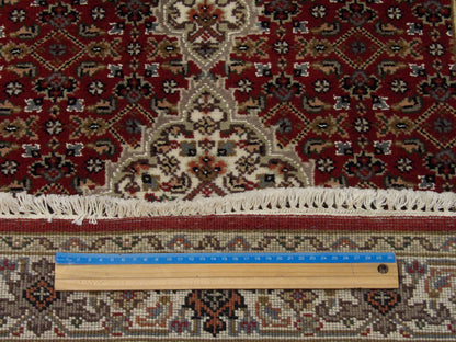 Beige & Red Fine Persian Tabriz rug in room setting