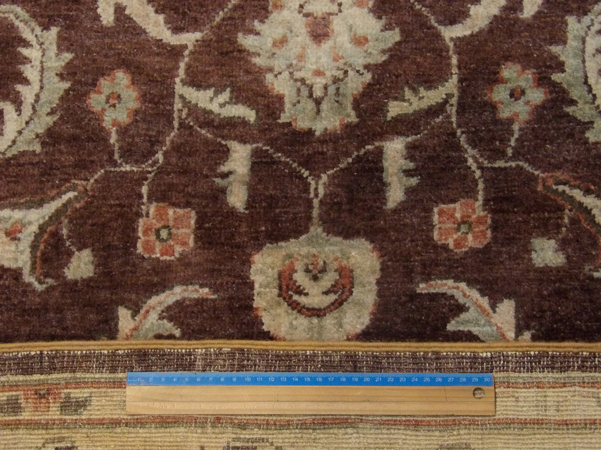 Brown and beige Oushak rug in room setting