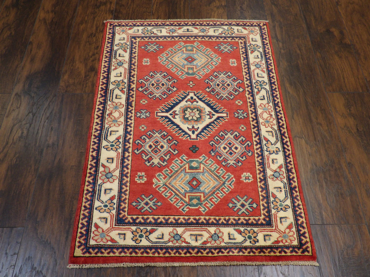 Close-up of wool pile, beige and red rug