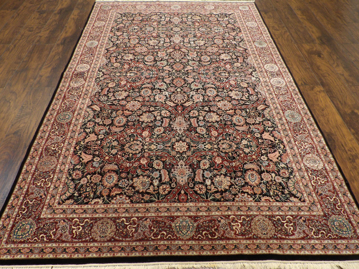 Close-up of wool-silk pile, black and red rug