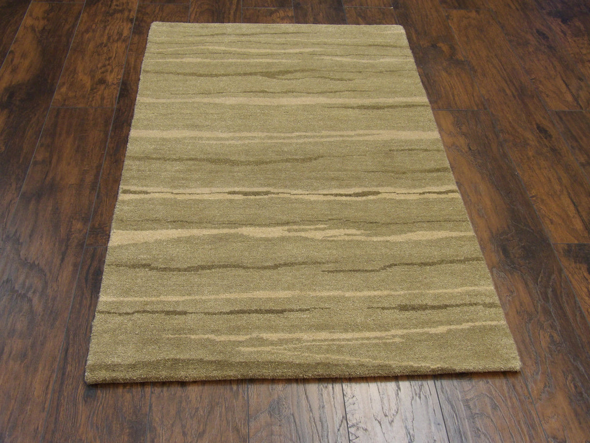 Close-up of wool pile, green modern rug