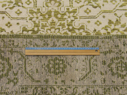 Green and ivory Heriz rug in room setting