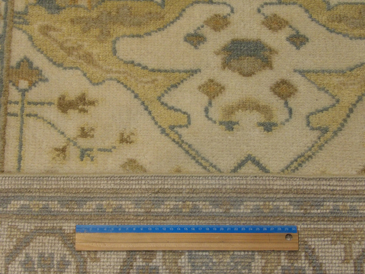 Beige Oushak rug in room setting
