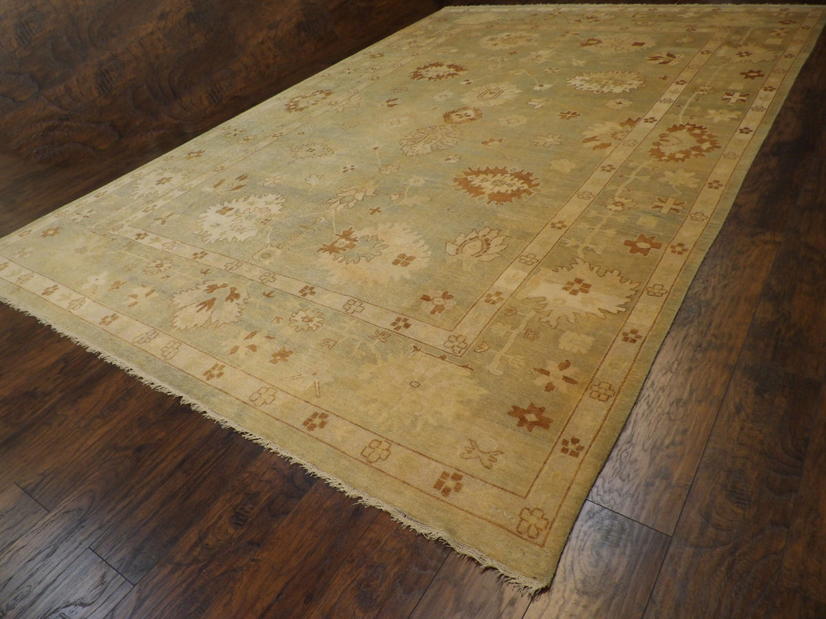 Green Oushak rug in room setting