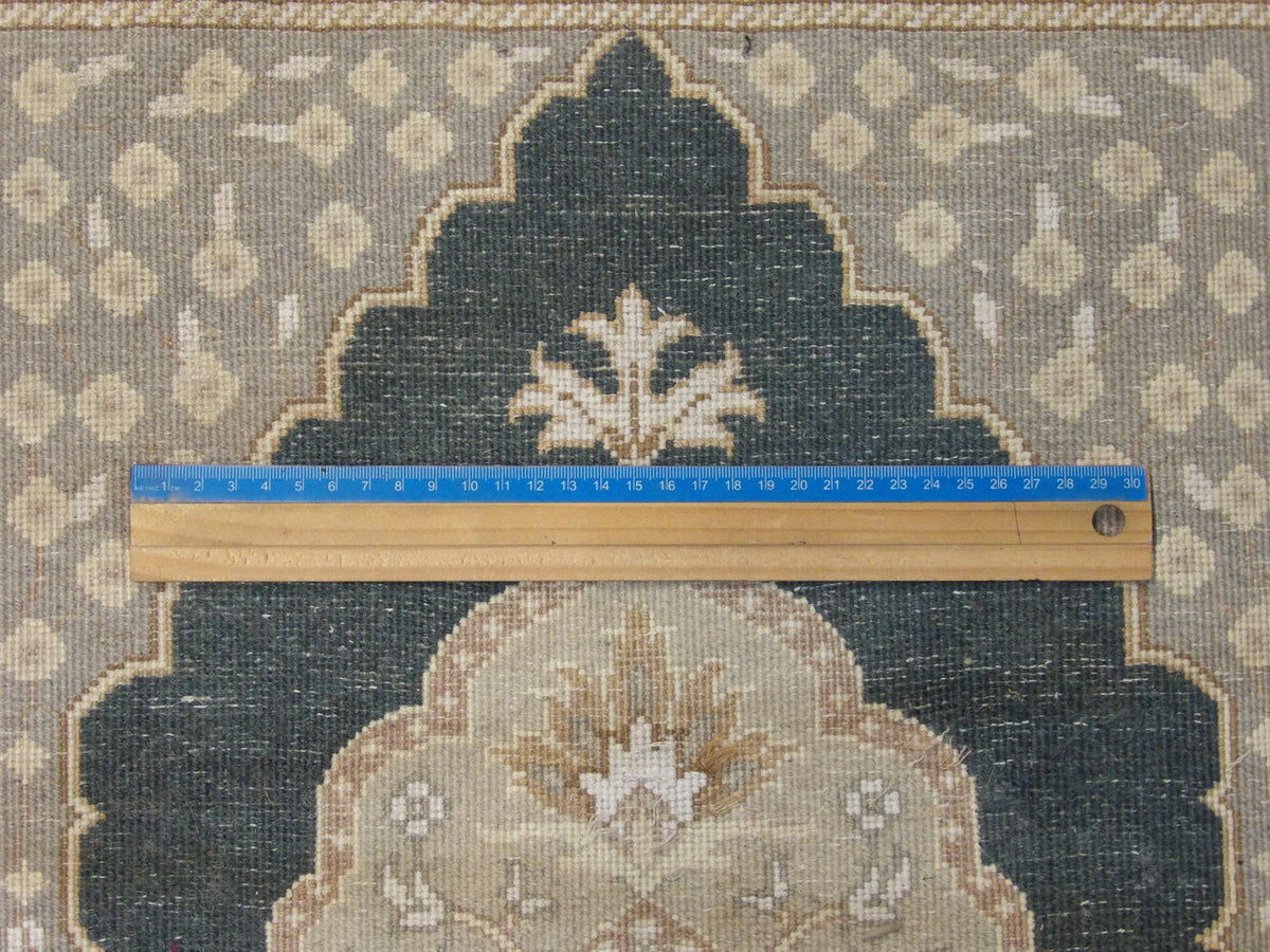 Beige & Teal Fine Persian Tabriz rug in room setting