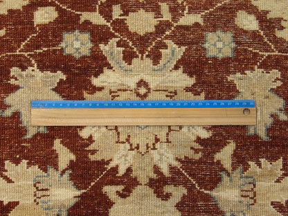 Beige and red Oushak rug in room setting