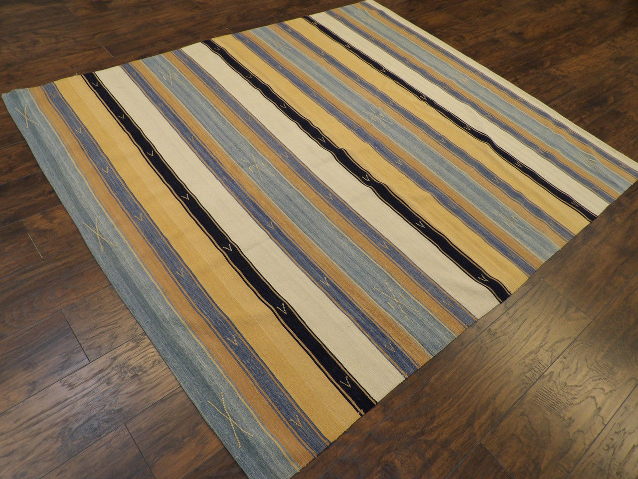 Brown and ivory striped kilim rug in a living room setting