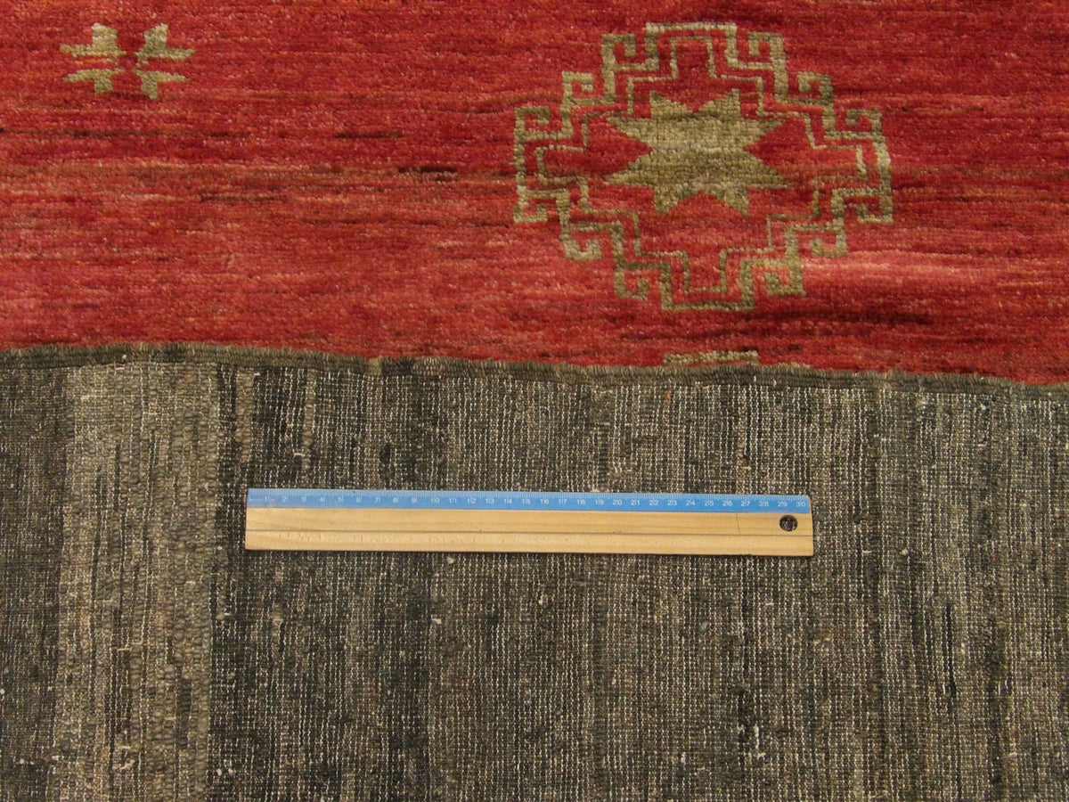 Gold & Red Antique Tribal Khotan . . rug in room setting