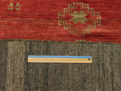 Gold & Red Antique Tribal Khotan . . rug in room setting