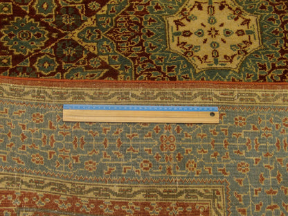 Green and rust Mamluk rug in room setting